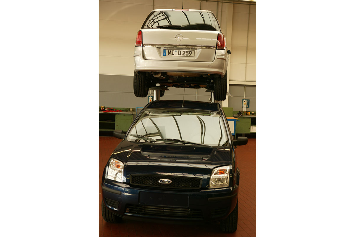 ein alter Ford steht unter einem Opel